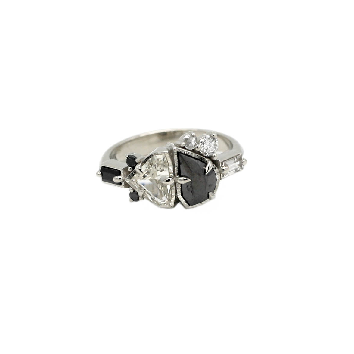 Asymmetric cluster ring with black and white diamonds, sapphires and gemstones in white gold on a white background